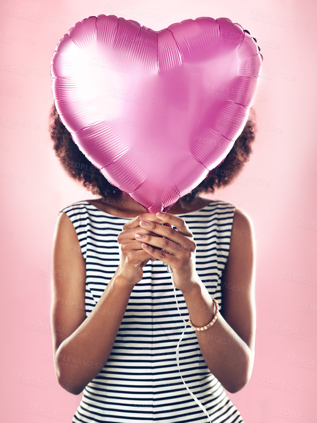 Buy stock photo Woman cover face with heart balloon in studio, pink background and celebrate surprise birthday party. Female model hide with helium, gift and present for love, valentines day and secret celebration