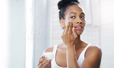 Buy stock photo Woman, face and mirror with cream for beauty, moisturizer and cosmetic product with morning routine in bathroom. Female person apply lotion to skin, skincare and dermatology at home with mockup space