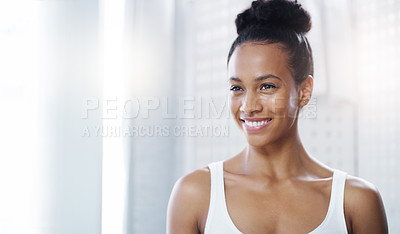 Buy stock photo Shot of an attractive young woman admiring her face in the bathroom at home