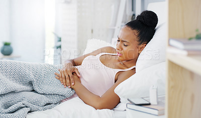 Buy stock photo Woman in bed, stomach pain and period cramps with  endometriosis, health problem and sick. Female person with digestion issue, abdominal ache and menstruation with gastrointestinal emergency at home