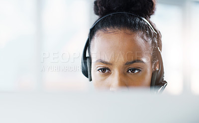 Buy stock photo Shot of an attractive young businesswoman wearing headsets while working in her office