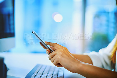 Buy stock photo Shot of an unrecognizable businesswoman using her cellphone at her office desk at work