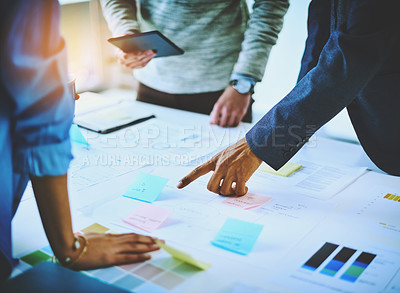 Buy stock photo Shot of a group of unrecognizable businesspeople discussing ideas during a boardroom meeting at work