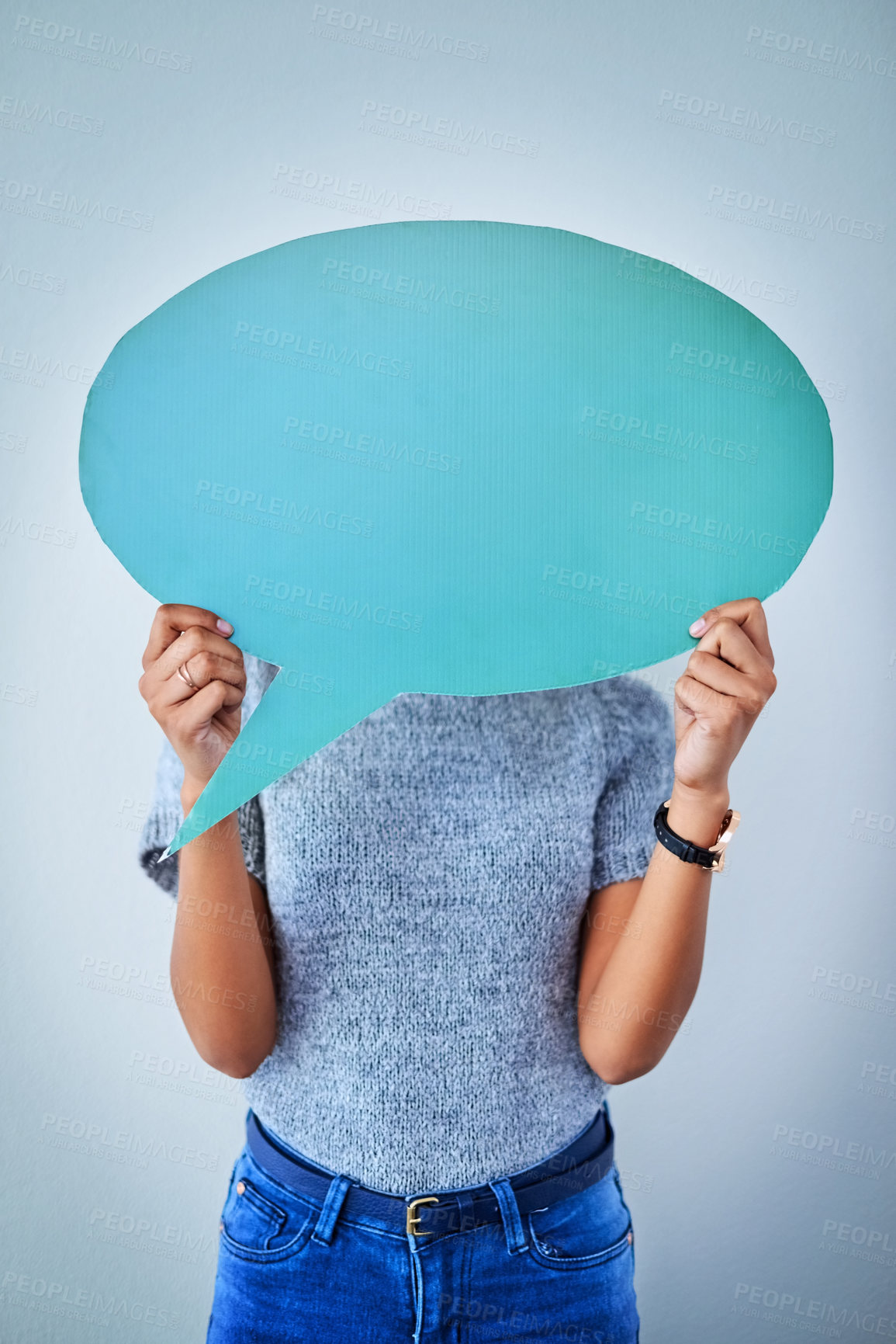 Buy stock photo Shot of an unrecognizable woman holding up a speech bubble against a blue background
