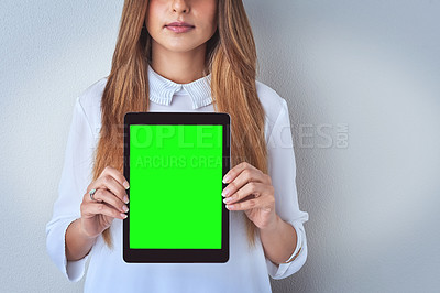 Buy stock photo Shot of an unrecognizable woman holding a digital tablet against a blue background
