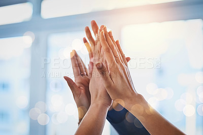Buy stock photo Shot of a group of unrecognizable businesspeople raising up their arms and joining their hands together in unity at work