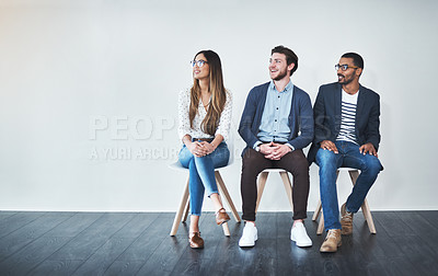 Buy stock photo Full length shot of a group of young businesspeople waiting in line for a job interview