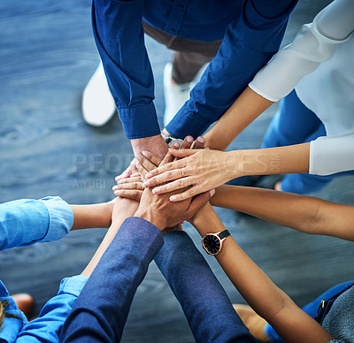 Buy stock photo High angle shot of a group unrecognizable businesspeople joining their hands together in unity