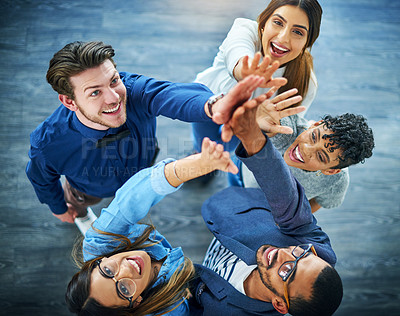 Buy stock photo High angle shot of a group of 
young businesspeople cheering in a modern office