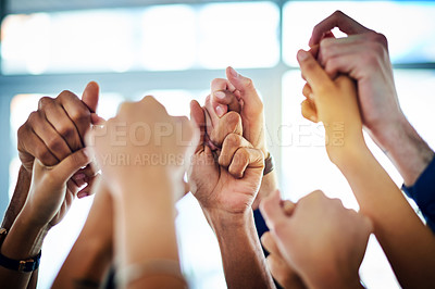 Buy stock photo Cropped shot of a group of unrecognizable businesspeople holding hands together in unity
