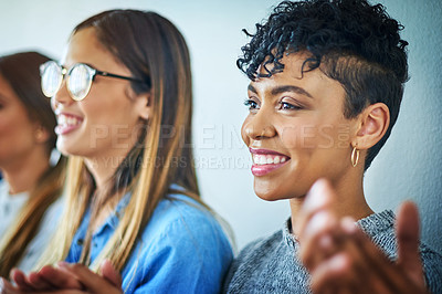 Buy stock photo Cropped shot of a group of attractive young businesswomen applauding during a conference in a modern office