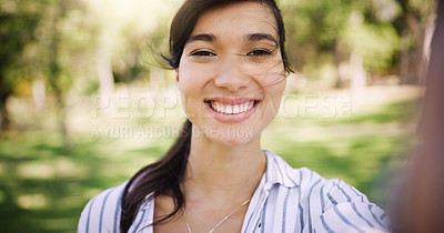 Buy stock photo Portrait of an attractive young woman taking a selfie while relaxing outdoors
