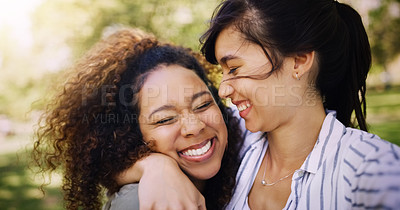 Buy stock photo Shot of two attractive young women posing together while relaxing outdoors