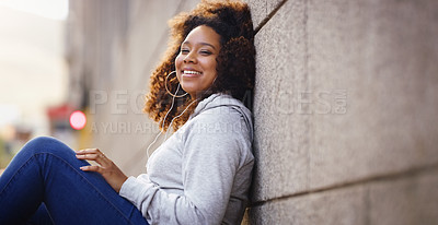 Buy stock photo Happy, relax and portrait of black woman by wall in city, urban town and street or by building in Houston, Texas. Earphones, student and gen z girl with smile for freedom, calm or listening to music