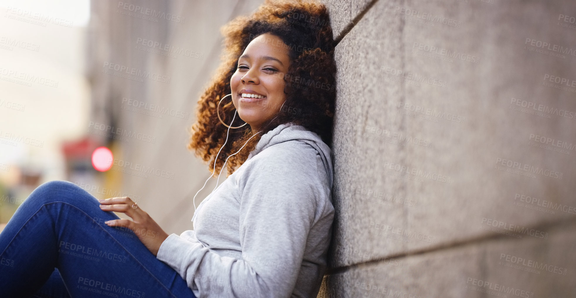 Buy stock photo Happy, relax and portrait of black woman by wall in city, urban town and street or by building in Houston, Texas. Earphones, student and gen z girl with smile for freedom, calm or listening to music