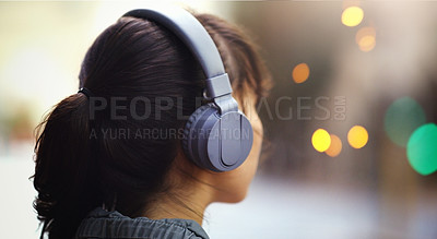 Buy stock photo Woman with headphones in city, back view and listening to music, bokeh and technology outdoor. Mockup space, podcast or radio streaming with female person in urban street and audio playlist