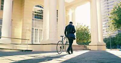 Buy stock photo Rearview shot of a businessman commuting to work with his bicycle