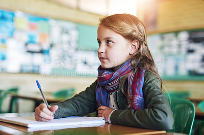 Buy stock photo Shot of an adorable little girl doing her school work in class