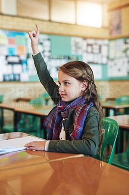Buy stock photo Shot of an adorable elementary schoolgirl raising her hand in class