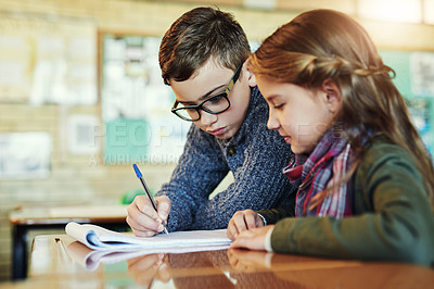 Buy stock photo Shot of two elementary school children working together in class