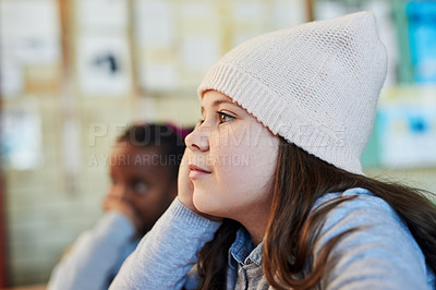 Buy stock photo Shot of a group of elementary school kids listening to their teacher in class