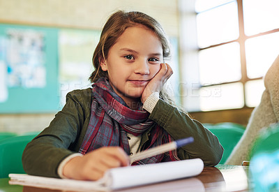 Buy stock photo Portrait of an adorable little girl doing her school work in class