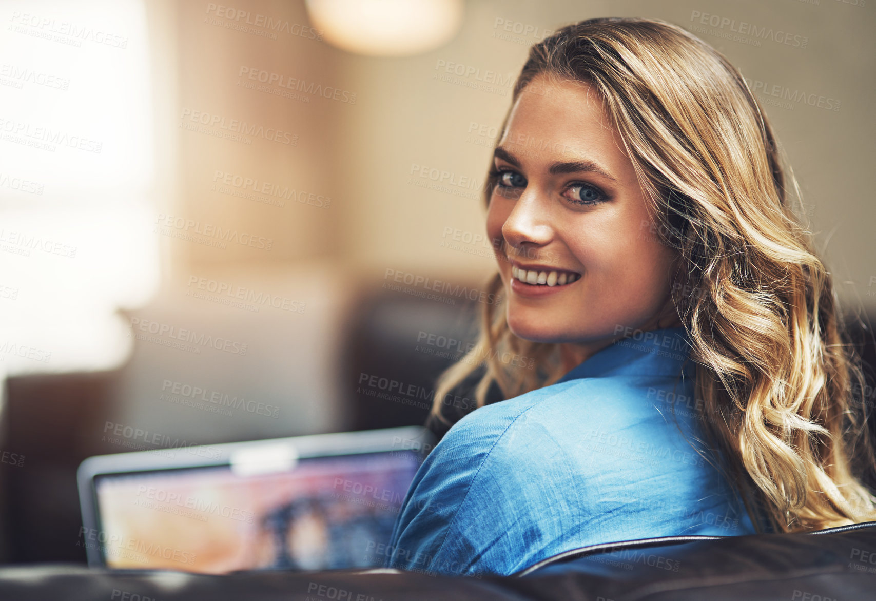 Buy stock photo Shot of a relaxed young woman using a laptop on the sofa at home