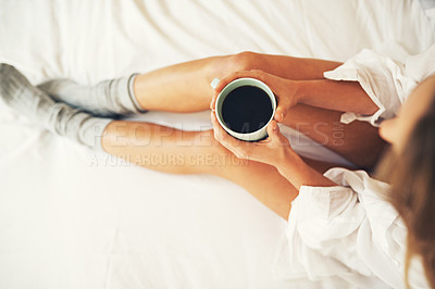 Buy stock photo High angle shot of a relaxed young woman having coffee in her bedroom at home