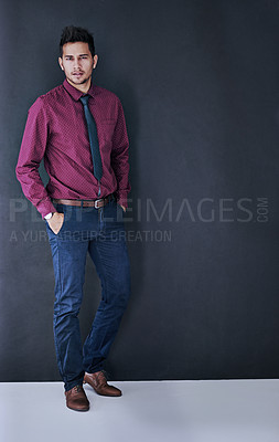 Buy stock photo Studio portrait of a handsome young businessman standing against a grey background