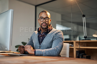 Buy stock photo Portrait of a focused young businessman working in his office
