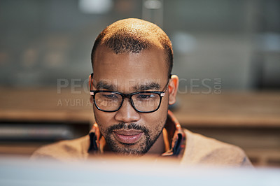 Buy stock photo Closeup shot of a handsome young businessman working in his office