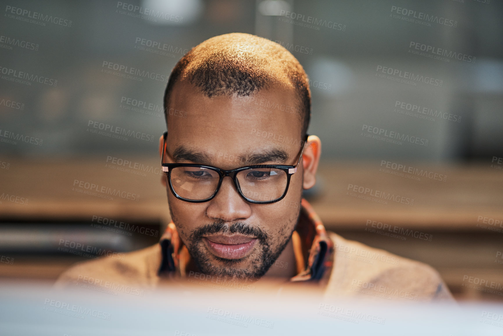 Buy stock photo Closeup shot of a handsome young businessman working in his office