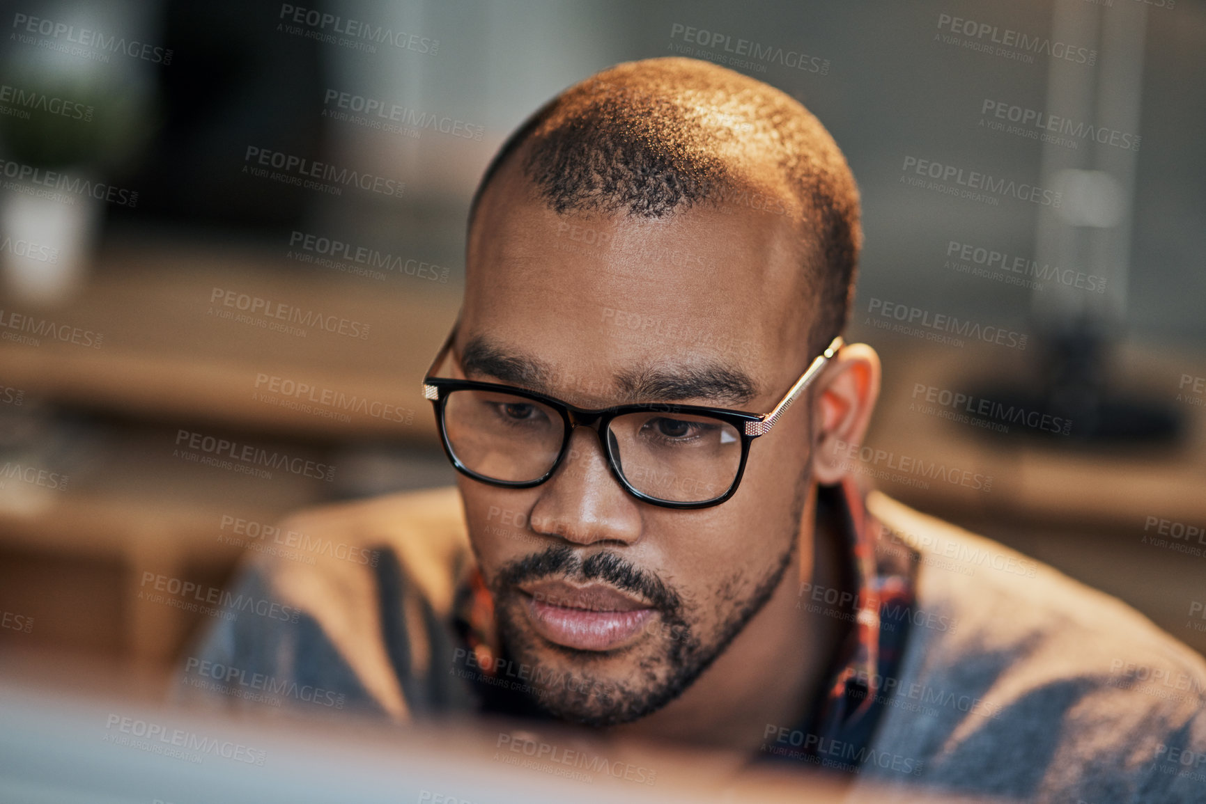 Buy stock photo Closeup shot of a handsome young businessman working in his office