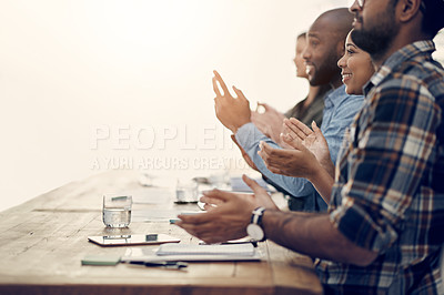 Buy stock photo Shot of a group of young businesspeople clapping during a meeting in a modern office