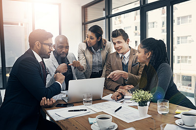 Buy stock photo Shot of a group of young businesspeople using a laptop together during a meeting in a modern office