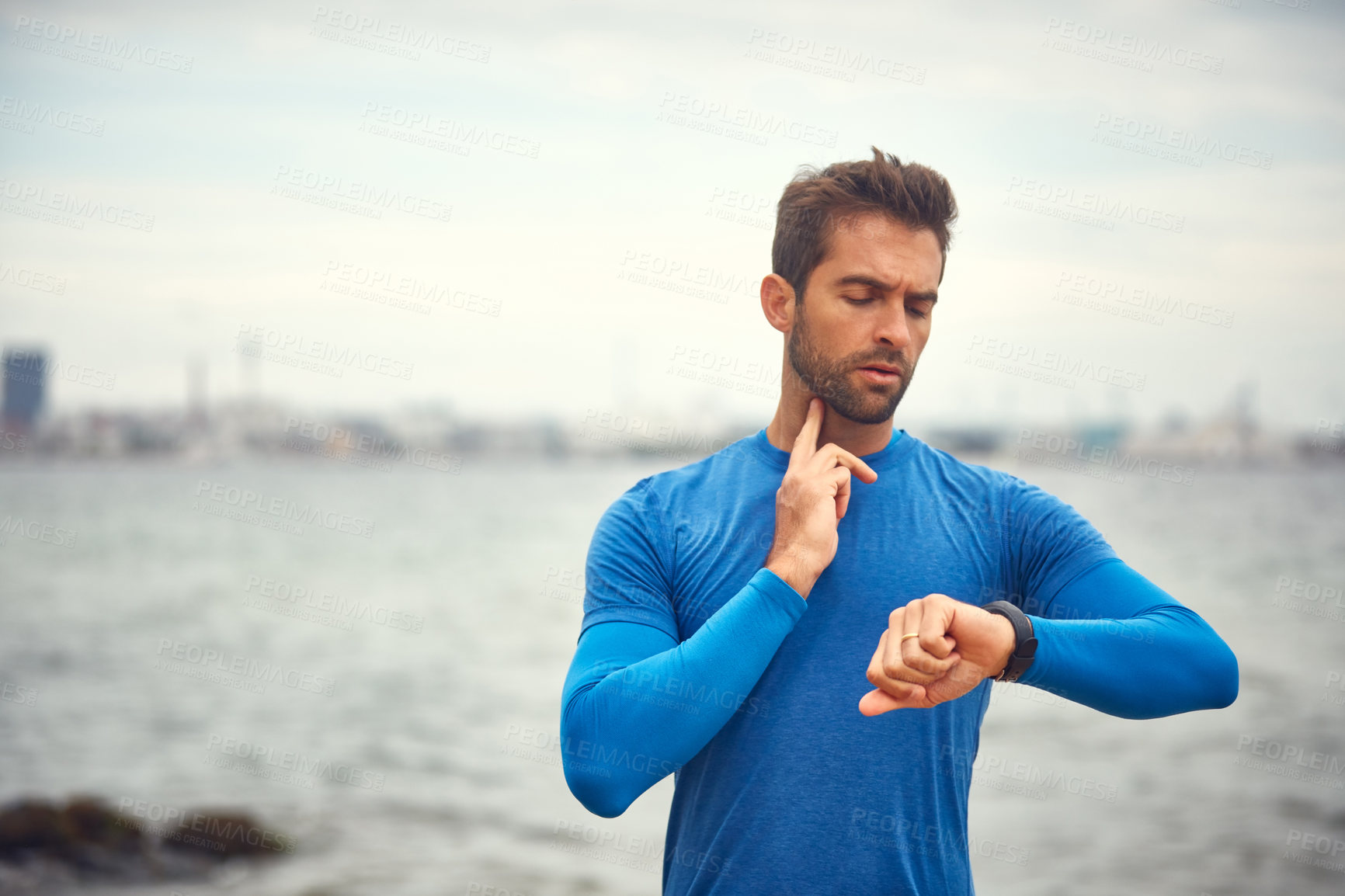 Buy stock photo Cropped shot of a sporty middle-aged man checking his pulse while out exercising