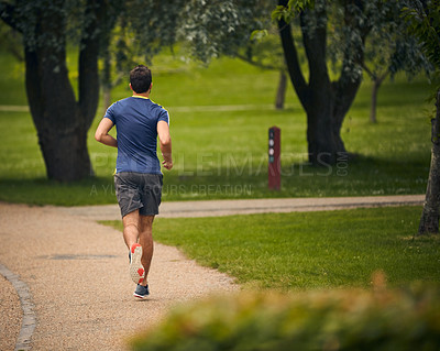 Buy stock photo Rearview shot of a sporty middle-aged man out running
