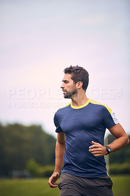 Buy stock photo Shot of a sporty man running outdoors