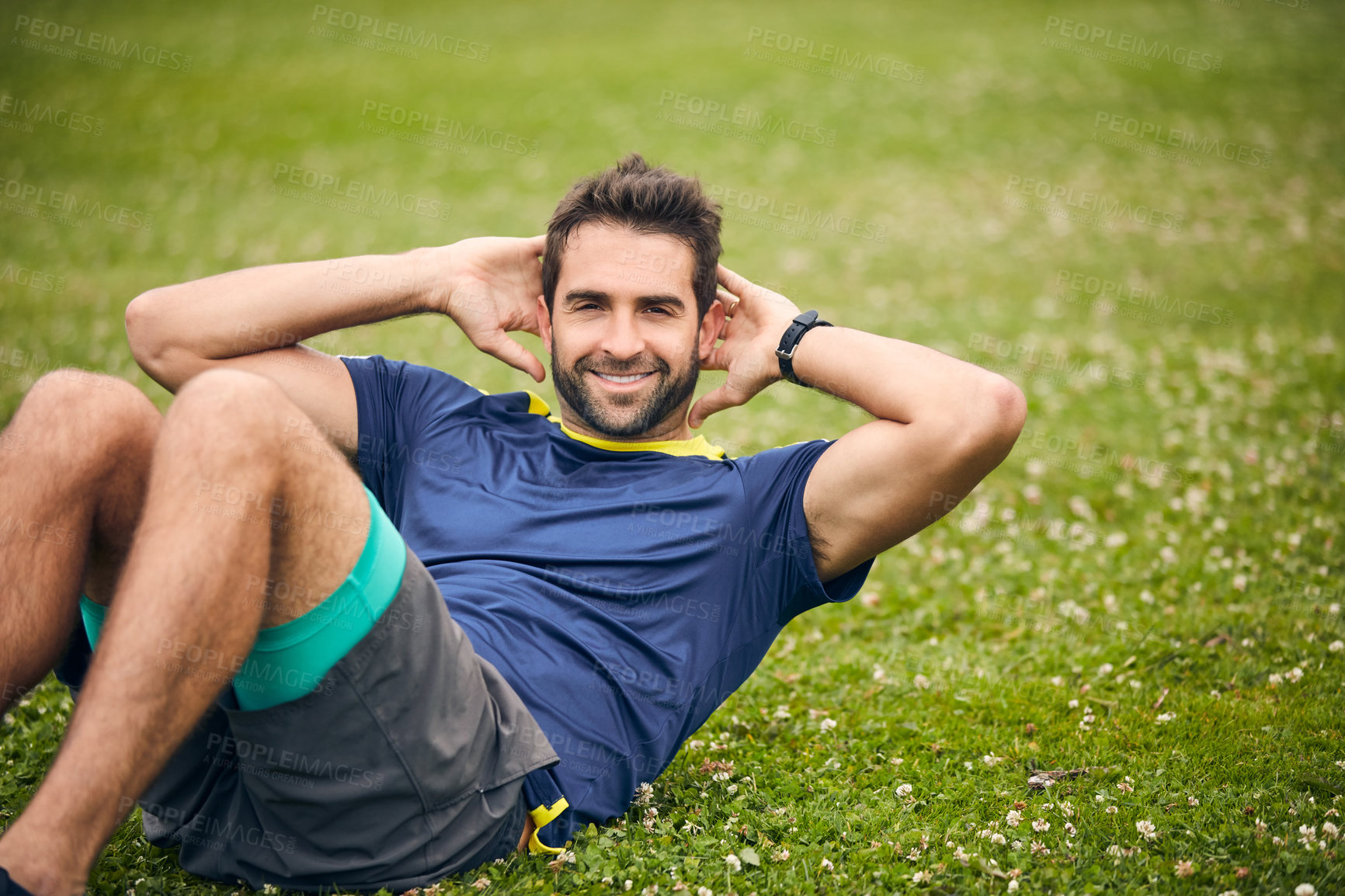 Buy stock photo Shot of a sporty man doing sit-ups