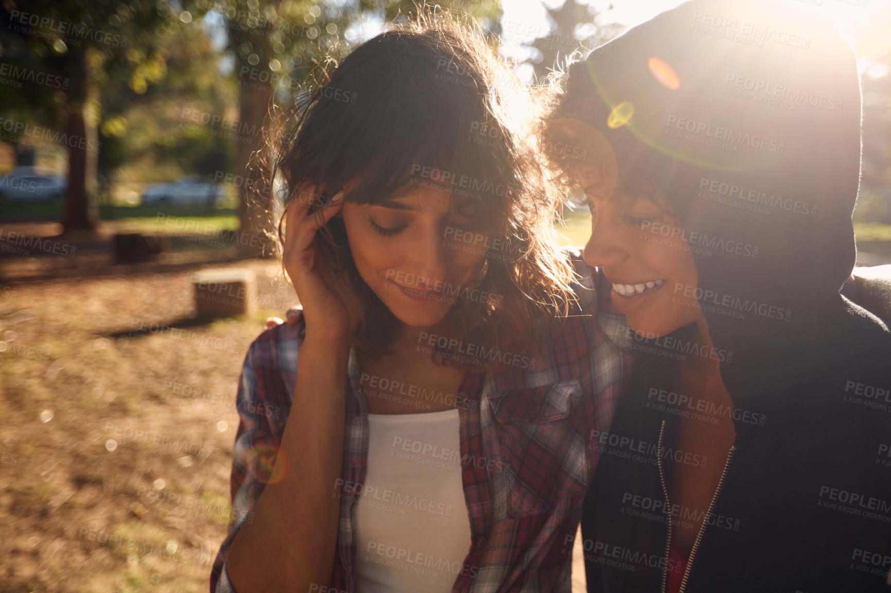 Buy stock photo Cropped shot of a young couple spending the day outdoors on a sunny day