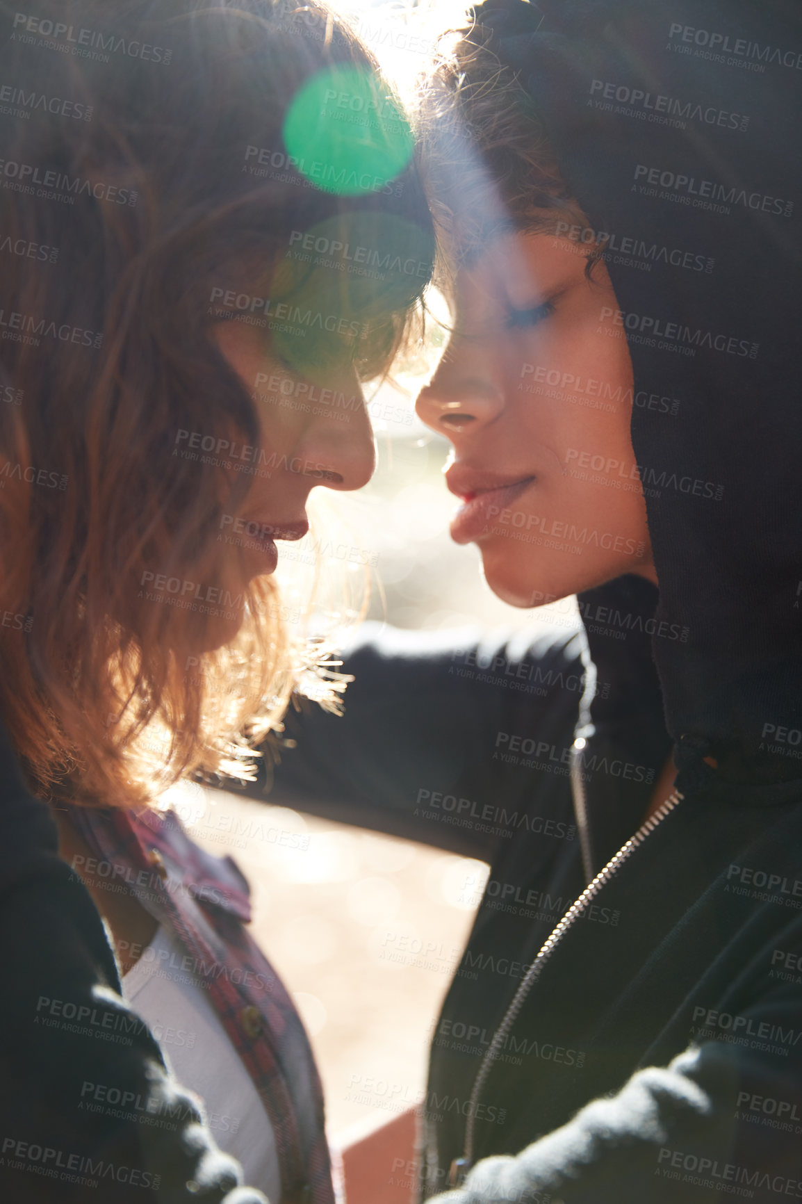 Buy stock photo Cropped shot of a young couple spending the day outdoors on a sunny day