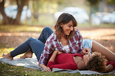 Buy stock photo Shot of a young couple spending the day outdoors on a sunny day