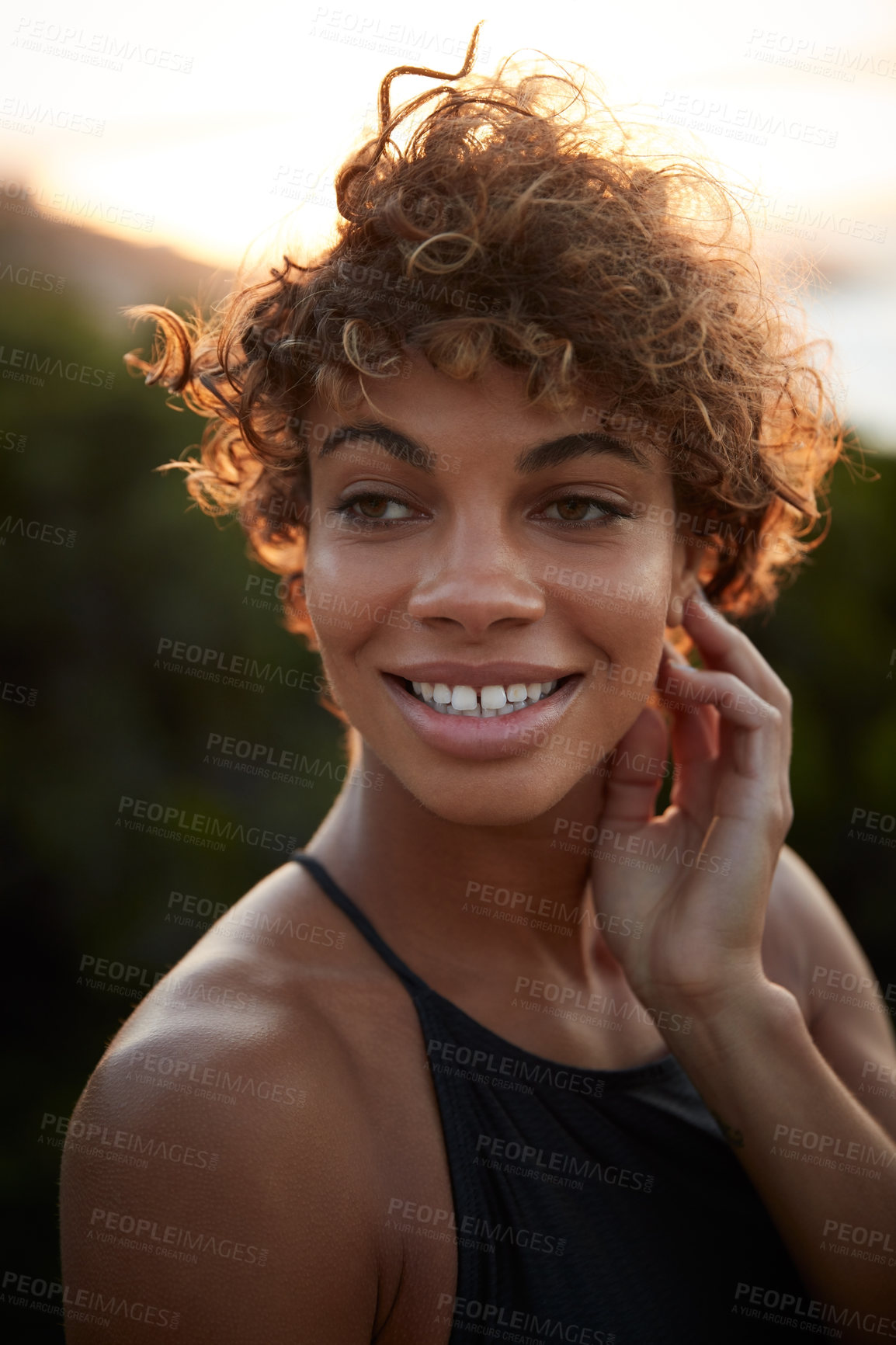 Buy stock photo Portrait of a beautiful young woman spending the day outdoors on a sunny day