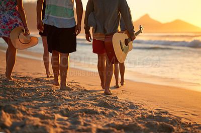 Buy stock photo Rearview shot of a group of unrecognizable friends walking together on the beach