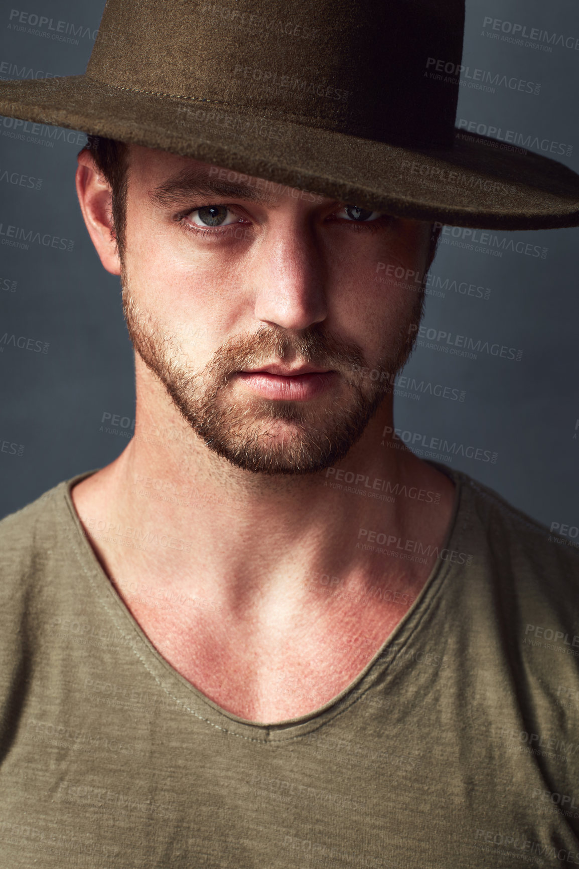 Buy stock photo Portrait, serious and man with hat, studio and stylish with clothes, cool and calm in fashion week. Confident, face and person with tshirt for runaway, model and creativity in grey background in USA