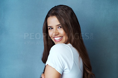 Buy stock photo Happy woman, portrait and fashion with hair for style in casual clothing on a blue studio background. Young brunette, female person or attractive model with smile or expression in joy on mockup space