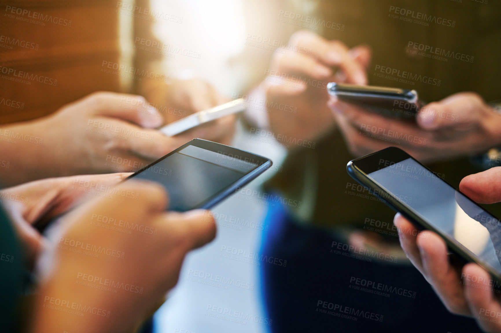 Buy stock photo Phone communication, networking and texting with a group of hands in a circle huddle and reading or sending a message online. Closeup of people typing, surfing the internet or browsing social media