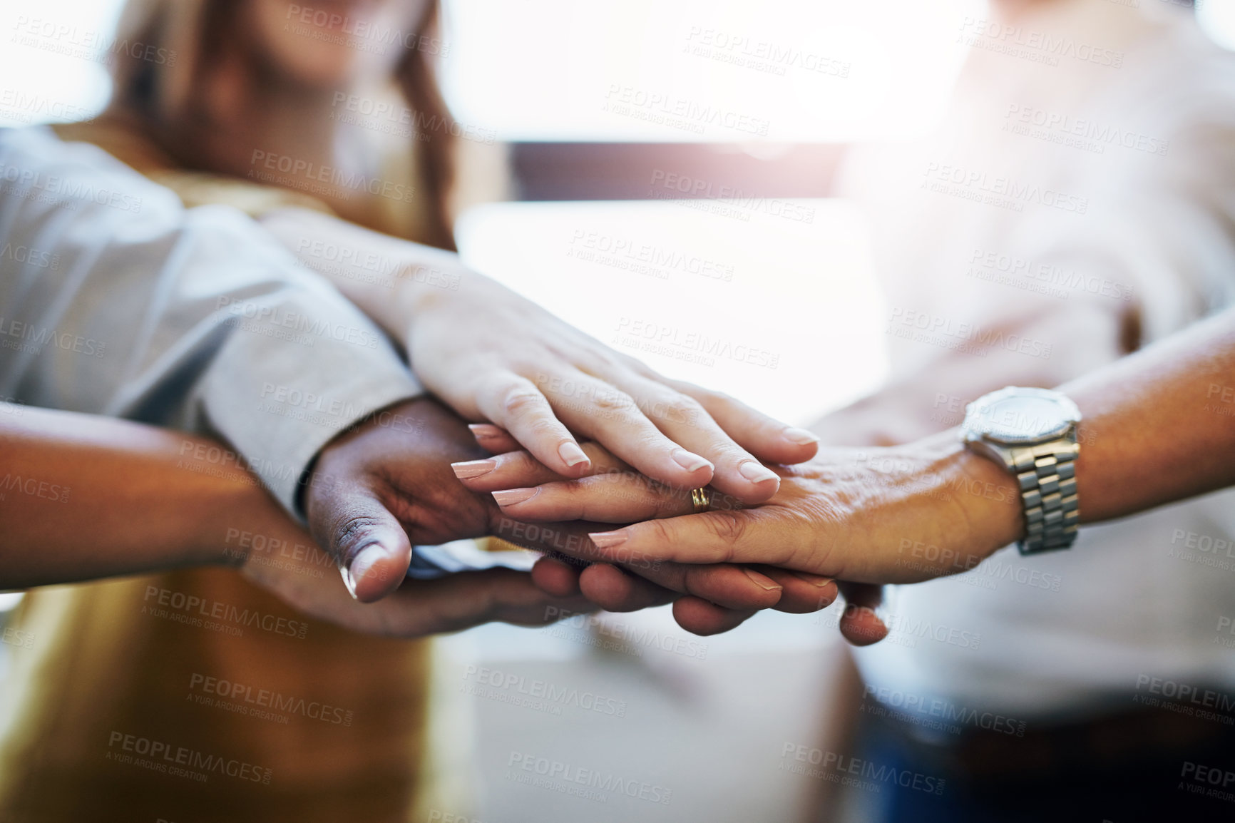 Buy stock photo Cropped shot of a group of unrecognizable colleagues joining their hands in solidarity at work