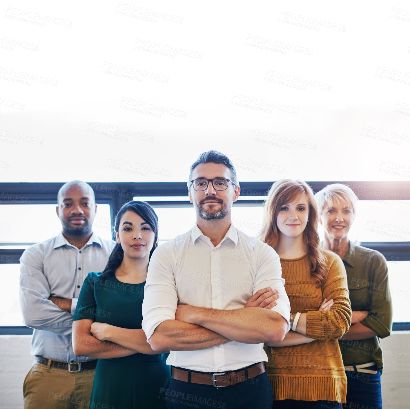 Buy stock photo Portrait of a group of confident and serious professionals standing together with arms crossed and copyspace. Serious team leader, manager or entrepreneur leading with support of staff and colleagues