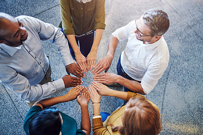 Buy stock photo Fun, collaboration and teamwork in hands linking during team building by diverse group of business people. Above happy investors showing support, trust and motivation while huddling, joining together